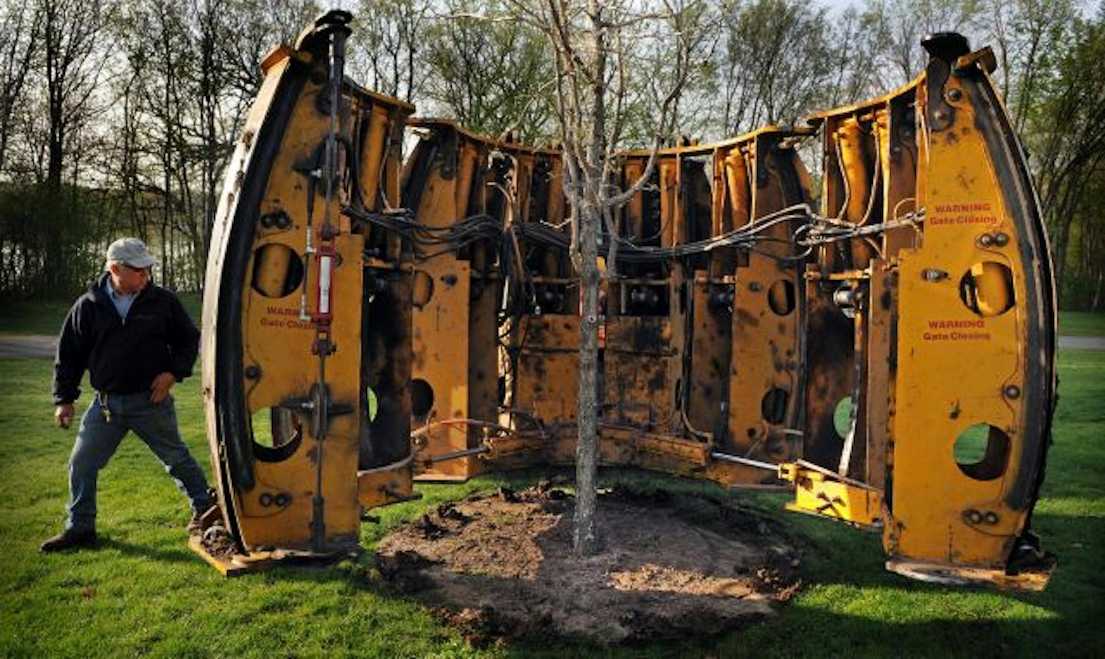 Invoking a lesson from the Dutch elm crisis, Three Rivers Park District is cutting down 10 percent of its ash trees each year and replacing them with new trees of various species. Forestry technician Dave Hugget finished planting a 14-foot bur oak in Hyland Park Reserve.