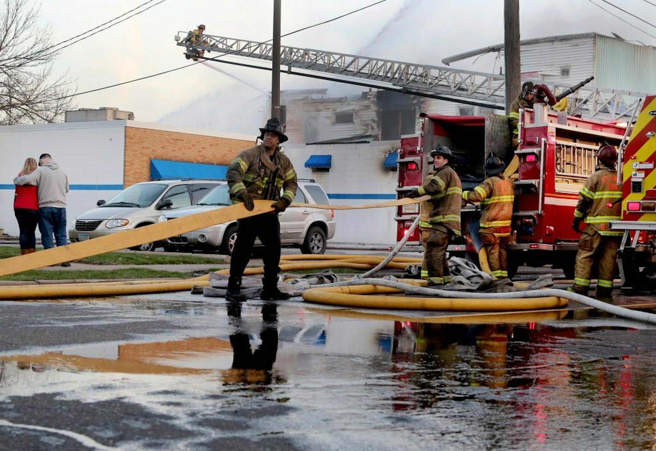 An early morning fire at Stasny's Food Market claimed the life of one male employee Thursday, April 14, 2016, in St. Paul, MN. Here, after the fire was brought under control firefighters begin picking up hose.