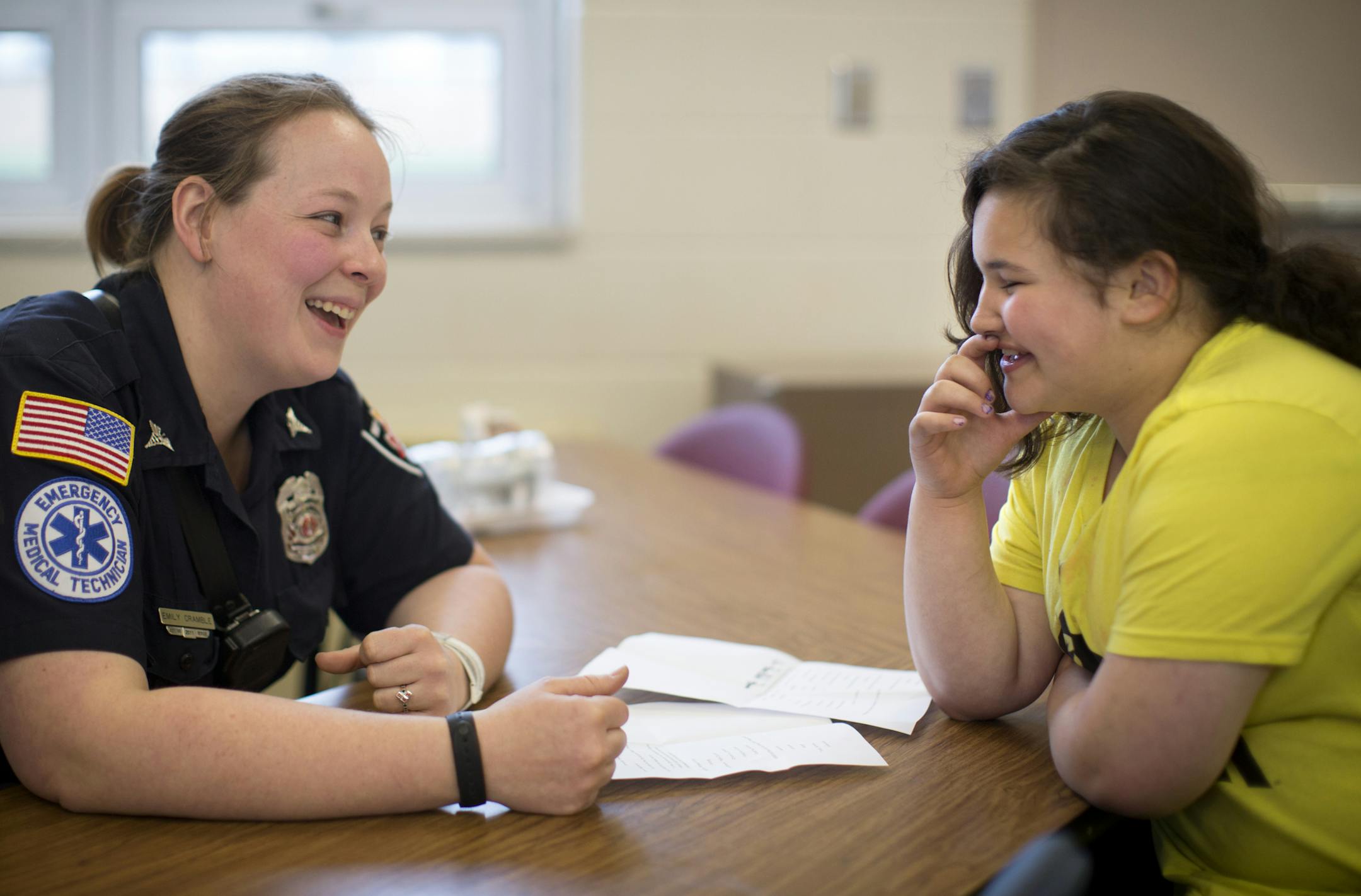 Fourth-grader Reanna Timoshenko and Columbia Heights firefighter Emily Cramble, her mentor, joked around about music.