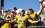 North Dakota State's Jaylaan Wimbush (23) celebrates with Aaron Steidl, left, and Zack Johnson, right, after defeating Eastern Washington in the FCS F