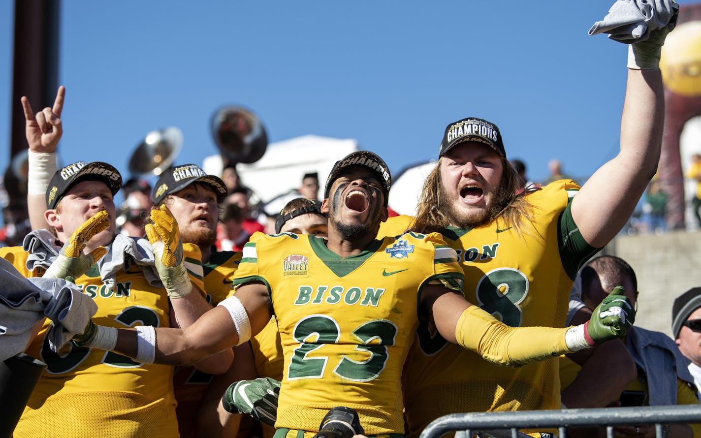 North Dakota State's Jaylaan Wimbush (23) celebrates with Aaron Steidl, left, and Zack Johnson, right, after defeating Eastern Washington in the FCS Football Championship NCAA college football game, Saturday, Jan. 5, 2019, in Frisco, Texas. (AP Photo/Jeffrey McWhorter)