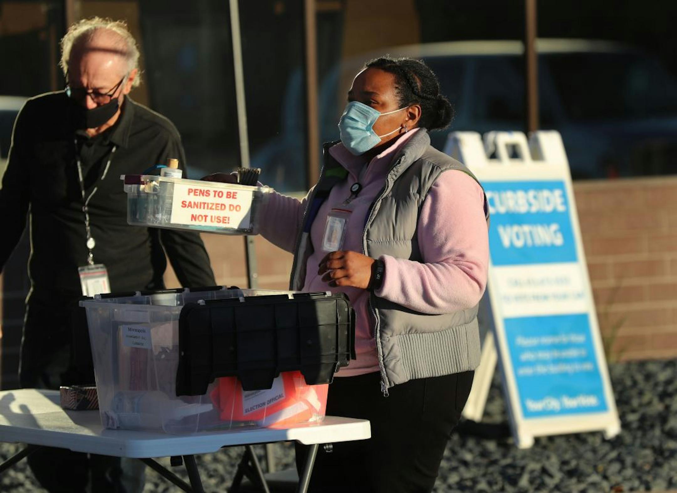 Election worker Simone Frierson prepared the curbside voting area for early voting at Minneapolis Elections and Voter Services Friday in Minneapolis.