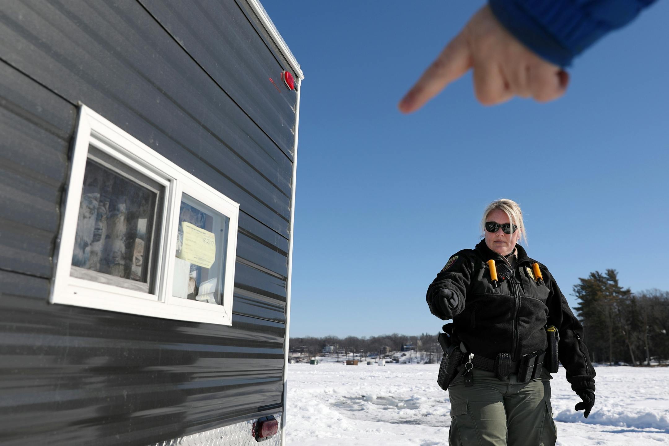 Minnesota Department of Natural Resources conservation officer Leah Weyandt looked over an ice fishing shelter Thursday at Lake Minnetonka.