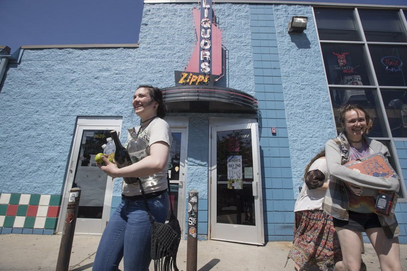 Customers dashed out of Zipps Liquors after buying booze on the first day Sunday for liquors sales in Minnesota.