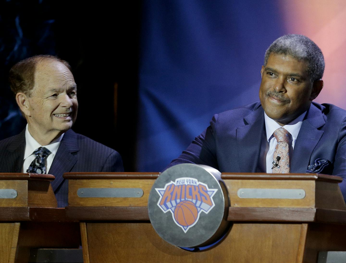 New York Knicks general manager Steve Mills, right, reacts as the Knicks take the fourth spot in the draft, during the 2015 NBA basketball draft lottery, Tuesday, May 19, 2015, in New York. Minnesota Timberwolves owner Glen Taylor is at left. The Timberwolves won the first pick in the draft. (AP Photo/Julie Jacobson)