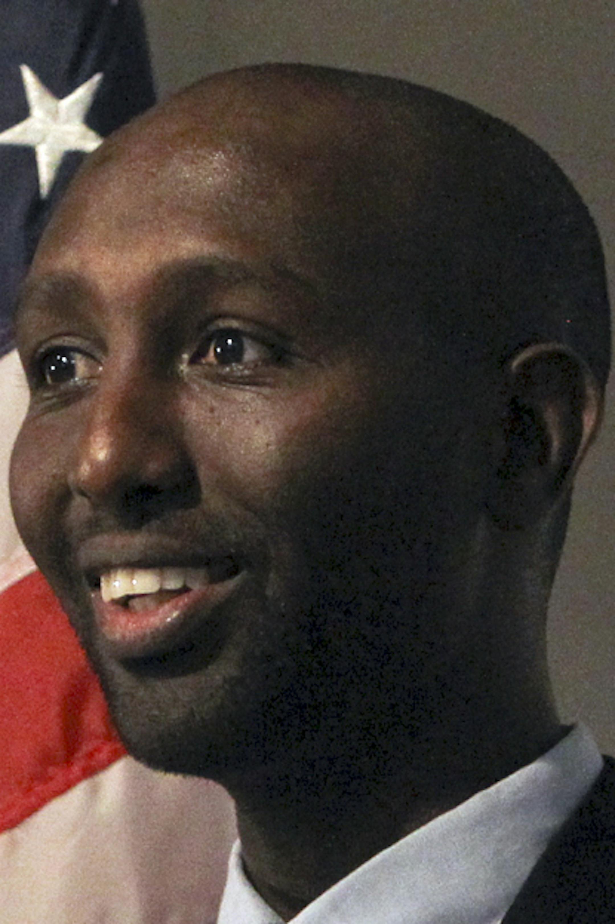 Relative political newcomer Mohamud Noor, left, introduced Somali political activist Jamal Abdulahi, who spoke to the audience. Earlier, Noor had announced the creation of a Somali PAC called the New Americans Political Action Committe to a gathering of mostly Somalis at the Safari Restaurant and Banquet Center Friday, Aug. 10, 2012, in Minneapolis, MN.] (DAVID JOLES/STARTRIBUNE) Story examines the political awakening of the Somali-American community in Minnesota. More Somalis are getting involv