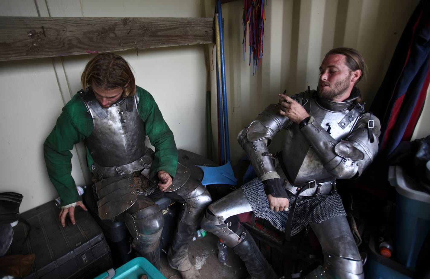 In this file photo, knights Sam Kuecker, left and Douglass Payne put on armor before the afternoon show at the Renaissance Festival in Shakopee, Minn., on Aug. 20, 2011.