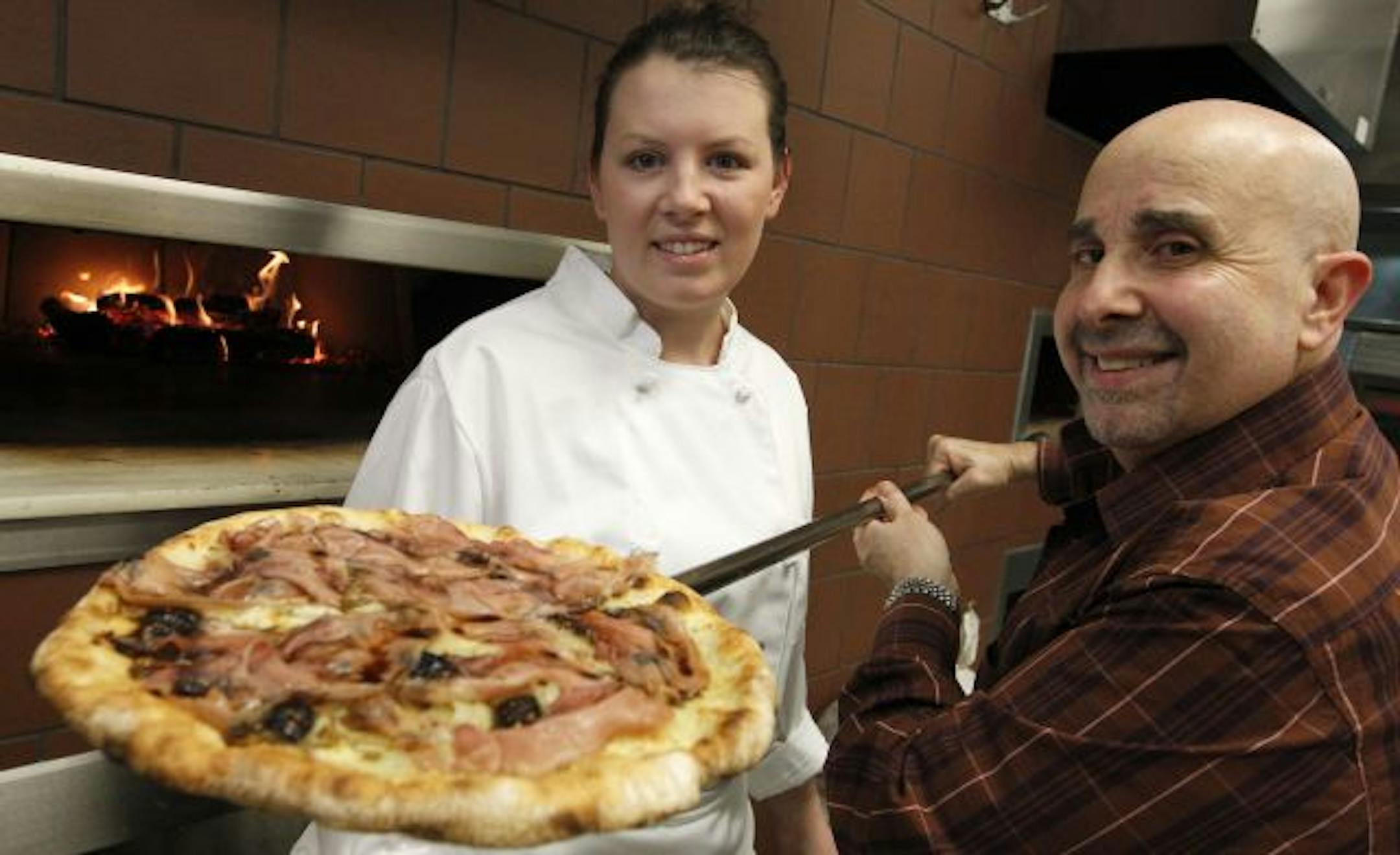Vittorio Renda and Heather Brinker tend the pizza ovens at Mozza Mia.