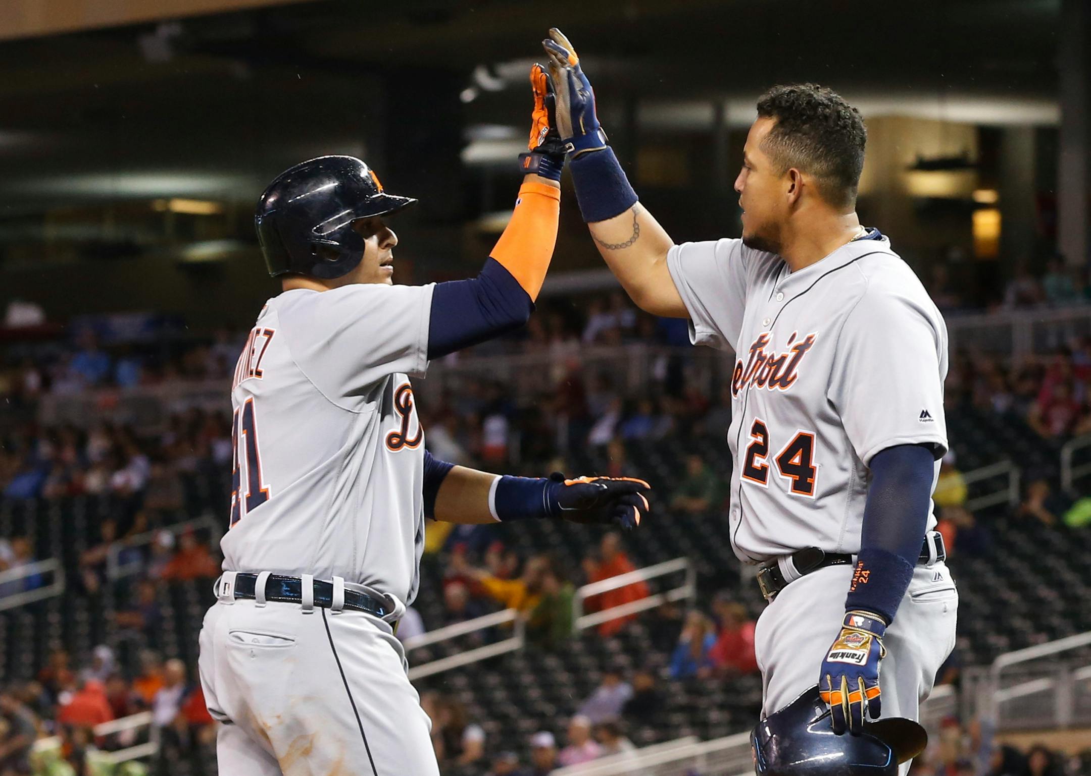Detroit Tigers' Miguel Cabrera, right, congratulates Victor Martinez after his two-run home run off Minnesota Twins pitcher Michael Tonkin during the seventh inning of a baseball game Tuesday, Aug. 23, 2016, in Minneapolis. (AP Photo/Jim Mone)