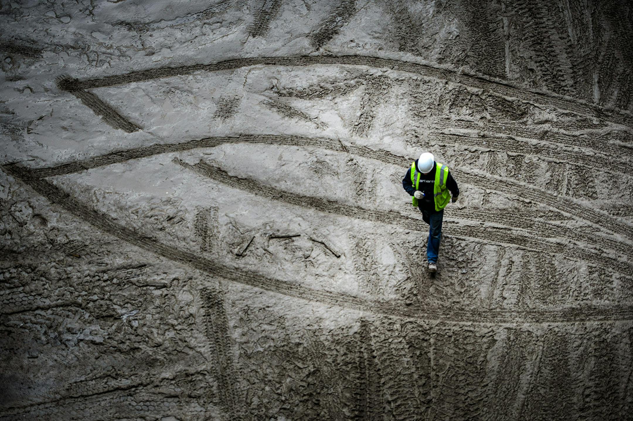 The new Vikings stadium under construction. Workers stepped around muddy puddles. Thursday, May 14, 2015 Construction update of the new Vikings stadium, Minneapolis, MN