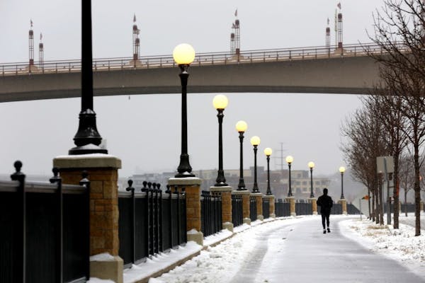 A runner enjoys isolation along the Mississippi River Trail in St. Paul during the first snowstorm of the season on Monday, November 10, 2014.