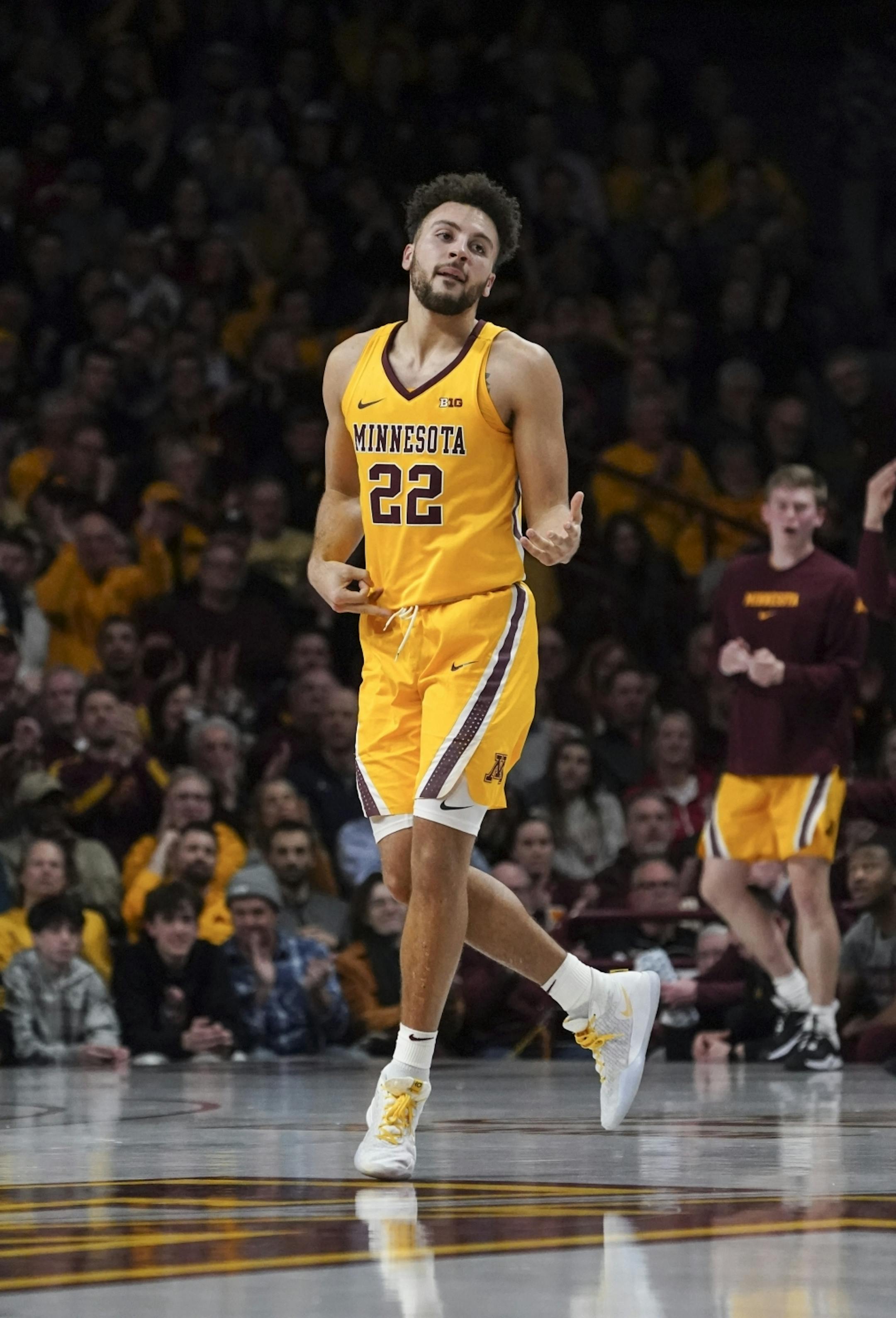 Minnesota Gophers guard Gabe Kalscheur (22) played air guitar to celebrate making a three point shot in the first half.