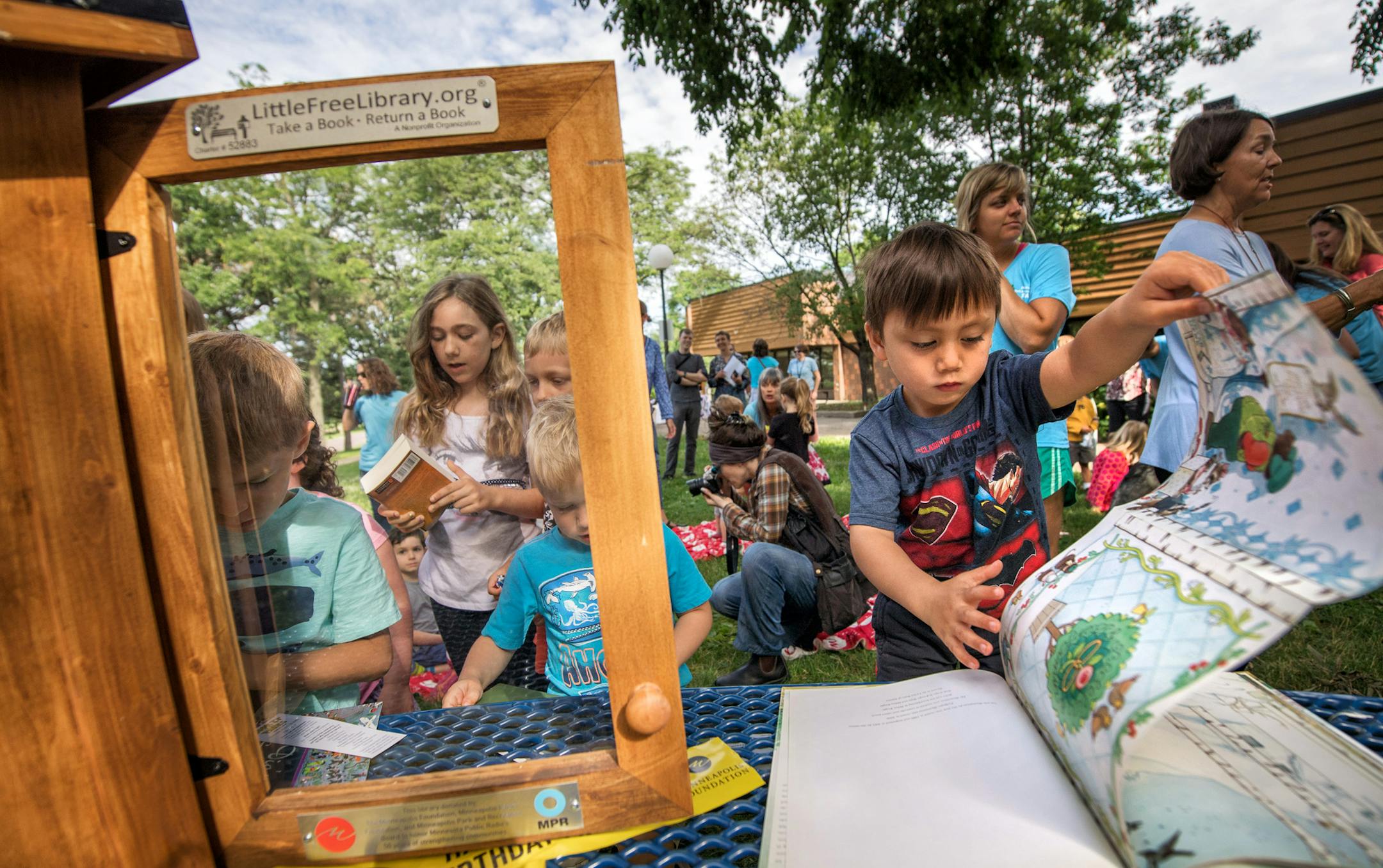 Kids looked through the Little Free Library books after the ceremony. ] GLEN STUBBE • glen.stubbe@startribune.com Wednesday June 21, 2017 More than 50 Free Little Libraries will open in Minneapolis neighborhood parks starting Wednesday as a gift from the Minneapolis foundation as way to encourage reading and celebrate MPR's 50th anniversary. This kickoff celebration was held at Lake Nokomis Community Center.