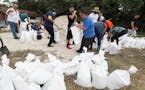 Dozens of Orange County residents fill sandbags at Blanchard Park in Orlando, Fla. on Wednesday, Aug. 28, 2019. The sandbags are being offered in adva