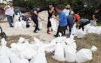 Dozens of Orange County residents fill sandbags at Blanchard Park in Orlando, Fla. on Wednesday, Aug. 28, 2019. The sandbags are being offered in adva