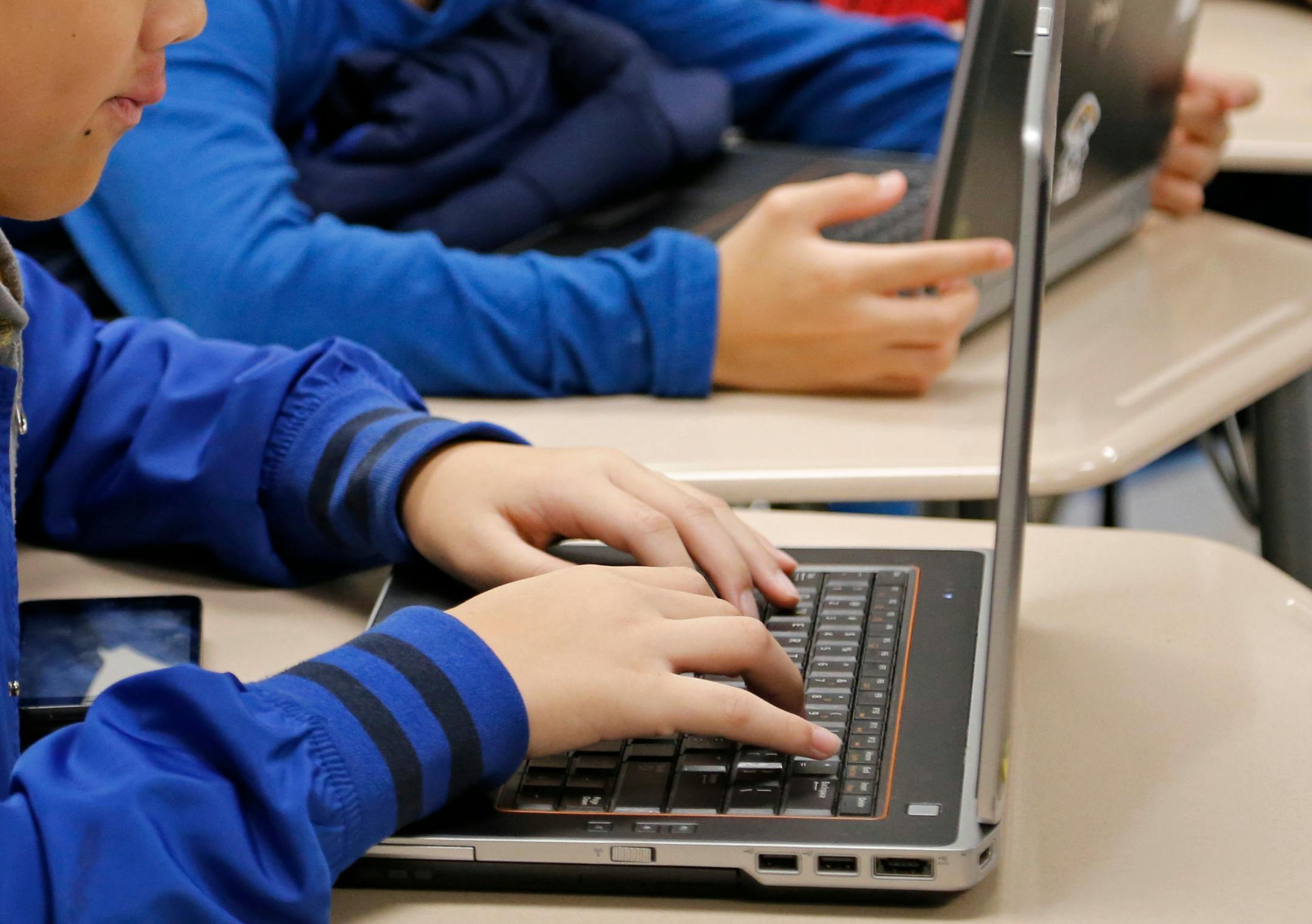 Students work on a laptop in a Minnesota school in 2018. PowerSchool, a provider of K-12 educational software, was recently hacked, exposing the personal data of students in schools across the nation.