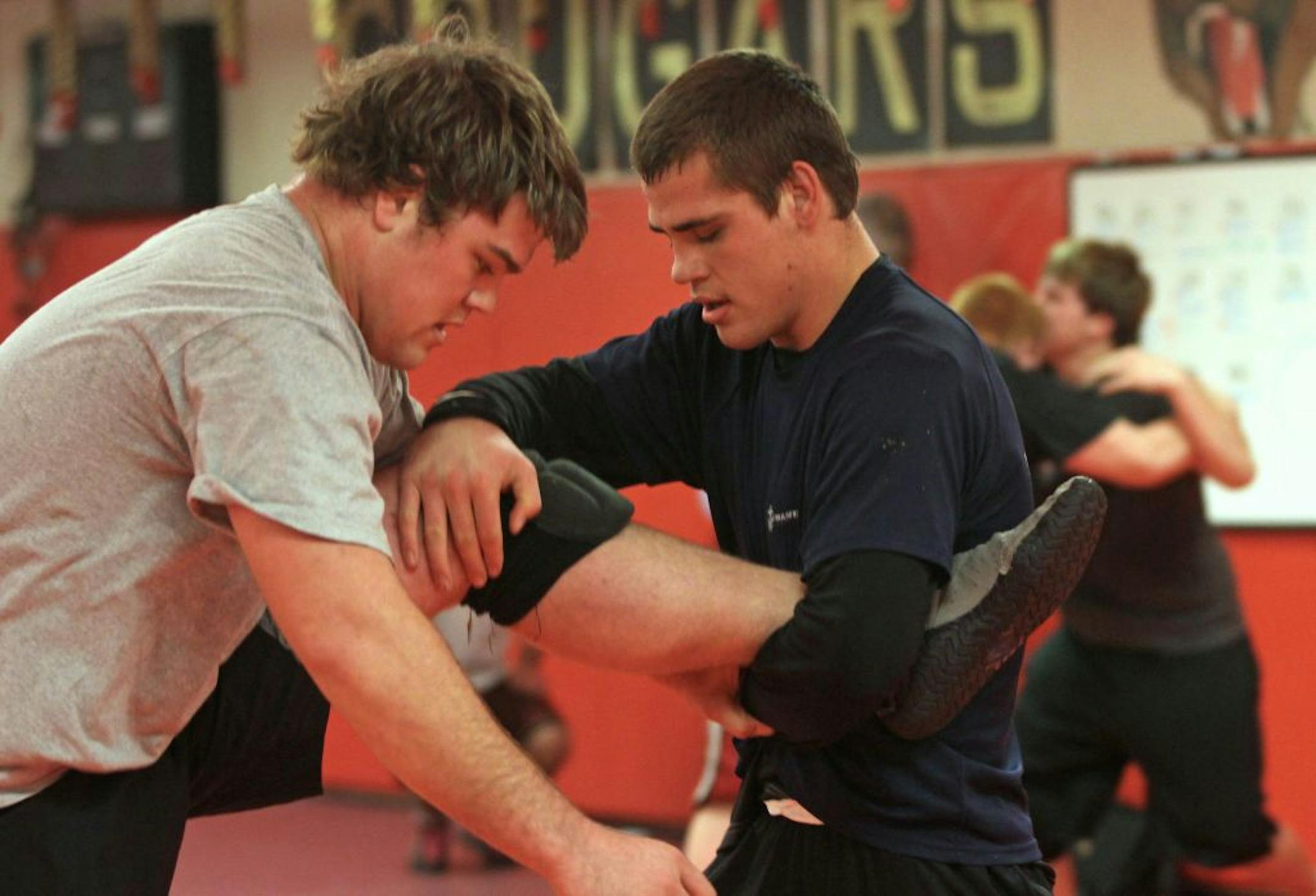 Zane Peterson, left, who is on winter break from Ridgewater College in Willmar, Minn., wrestled with his younger brother Tommy Peterson during practice at Lakeville South. Photo by Bruce Bisping • bbisping@startribune.com