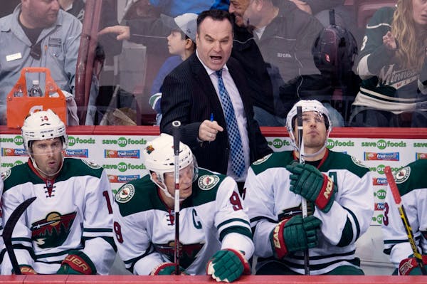Wild interim coach John Torchetti gave instructions on the bench during his debut Monday night at Vancouver.