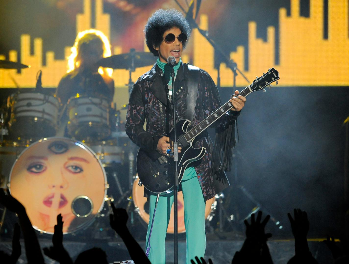 FILE - In this May 19, 2013 file photo, Prince performs at the Billboard Music Awards at the MGM Grand Garden Arena in Las Vegas. Several pills taken from Prince's estate in Paisley Park after his death were counterfeit drugs that actually contained fentanyl,a synthetic opioid 50 times more powerful than heroin, an official close to the investigation said Sunday, Aug. 21, 2016. (Photo by Chris Pizzello/Invision/AP, File)