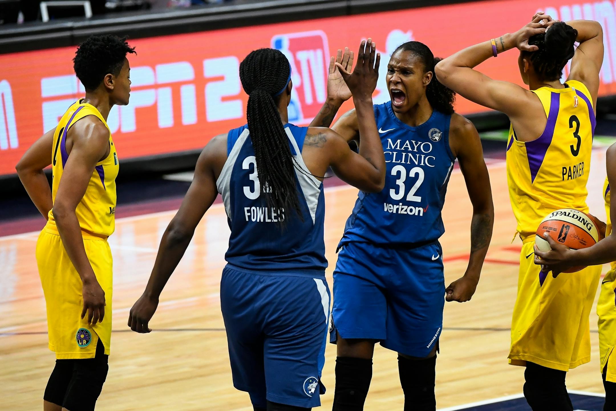 Minnesota Lynx forward Rebekkah Brunson (32) celebrated with Minnesota Lynx center Sylvia Fowles (34) after Fowles was fouled by Los Angeles Sparks forward Candace Parker (3) during a layup creating an and-one opportunity in the first quarter.