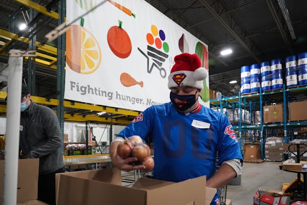 More than a dozen volunteers packed and sorted food at the Food Group in New Hope on Friday, Dec. 18, 2020. In this photo, James Gottfried, a frequent
