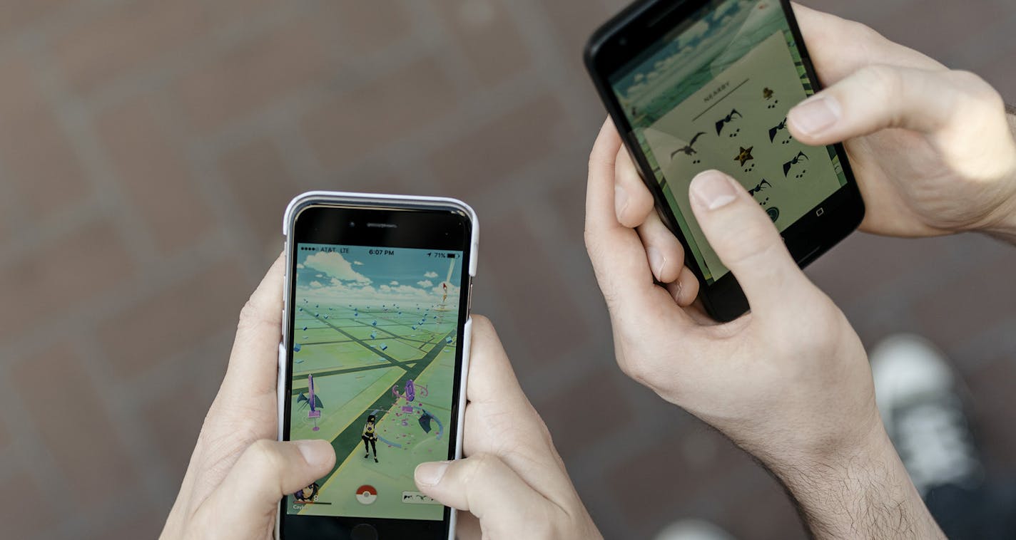 Diego Escudero and Kay Collins play Pokemon Go on the streets of San Francisco, July 10, 2016. The free smartphone game, which sends users outdoors to track down Pokemon, has been such a raging success that Nintendo&#xed;s market capitalization has soared by billions in the week of its release. (Jason Henry/The New York Times) ORG XMIT: MIN2016071117120828