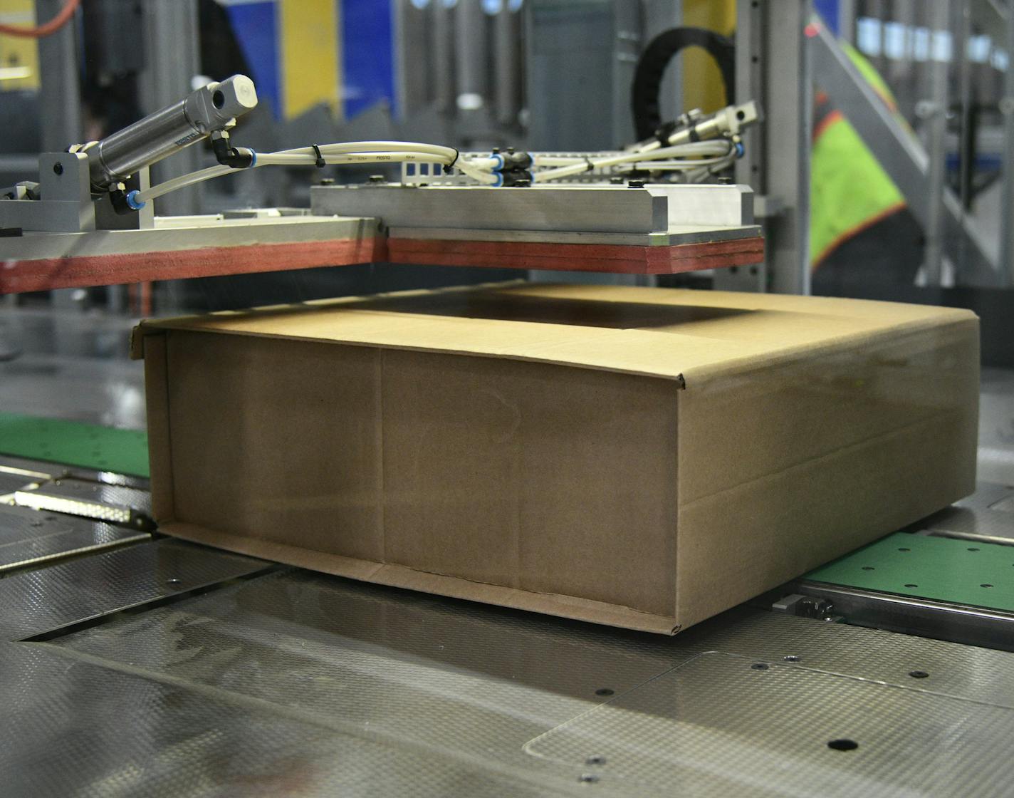 A machine at the Best Buy warehouse in Compton, Calif., builds shipping boxes to the exact size of the item, eliminating waste and the need for plastic bubble.(Best Buy photo)