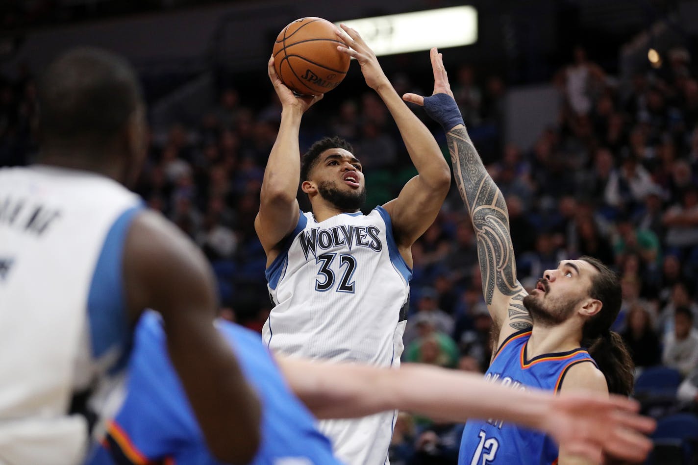 Minnesota Timberwolves center Karl-Anthony Towns (32) takes a shot over the head of Oklahoma City Thunder center Steven Adams (12) during the first half earlier this month.