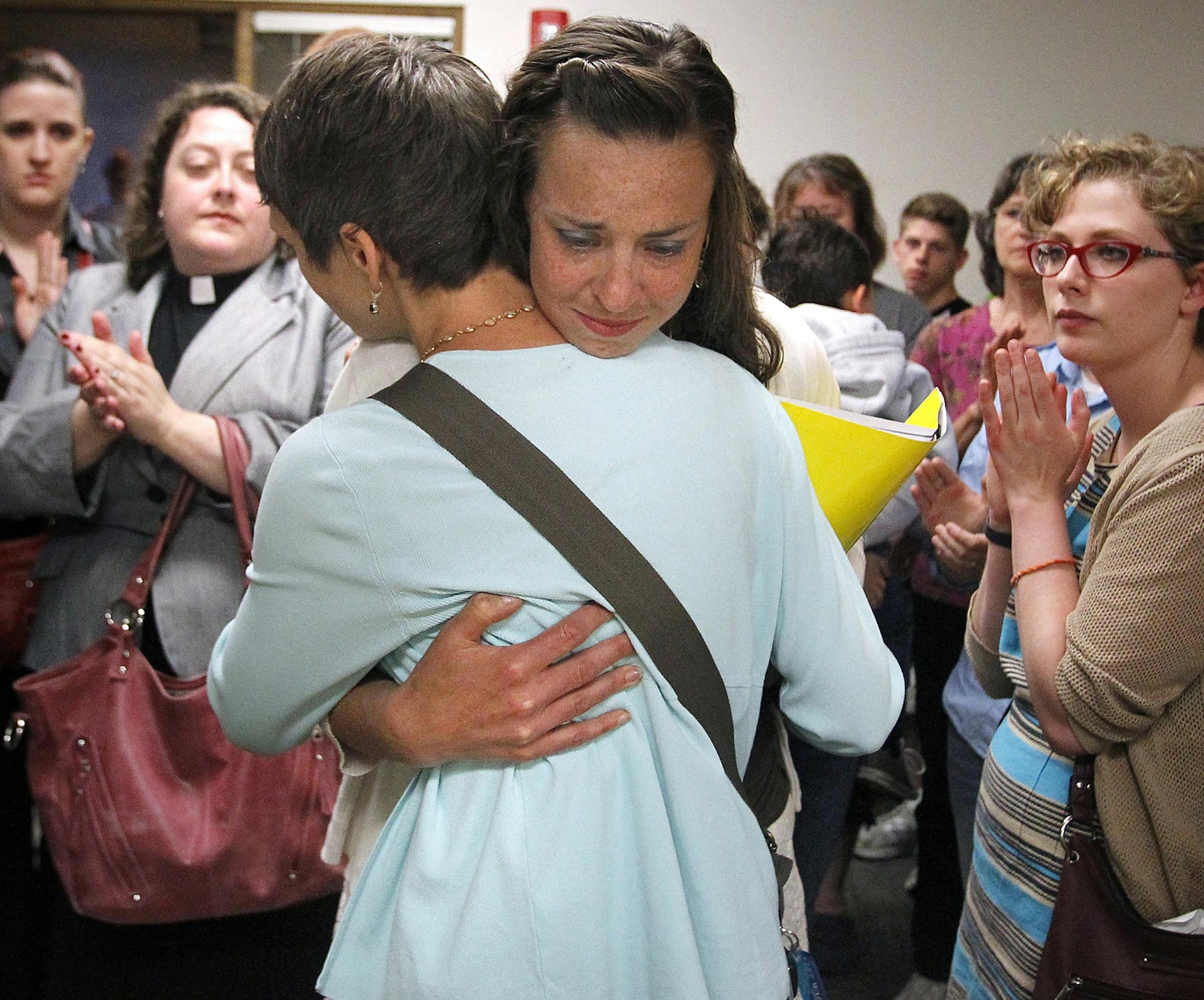 Sam Tasoul, left, and Sara Rabideau embrace after being denied a marriage license by Outagamie County Clerk Lori O'Bright on June 9, 2014 in Appleton, Wis. O'Bright said she was waiting on authorization from the state before issuing licenses. The decision was later reversed and applications for marriage licenses were accepted, subject to a five day waiting period. (AP Photo/The Post-Crescent, Wm.Glasheen) NO SALES Wm.Glasheen/Post-Crescent Media