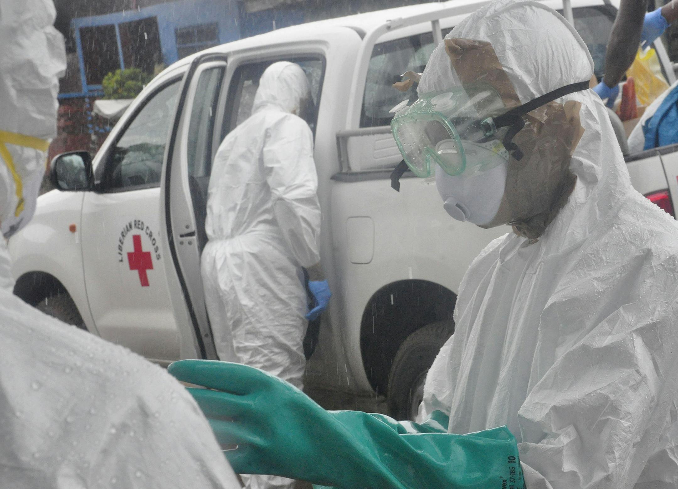 Health workers dressed in protective gear prepare to load the body of a woman suspected to have died from Ebola virus, in New Kru Town at the outskirt of Monrovia, Liberia, Wednesday, Oct. 8, 2014. Liberia has been among the hardest hit nations at the centre of the long outbreak, which has killed more than 3,000 people, as of Friday, there had been 3,834 confirmed Ebola cases and 2,069 deaths in Liberia, according to the World Health Organization. Forty-four percent of the Ebola cases were repor