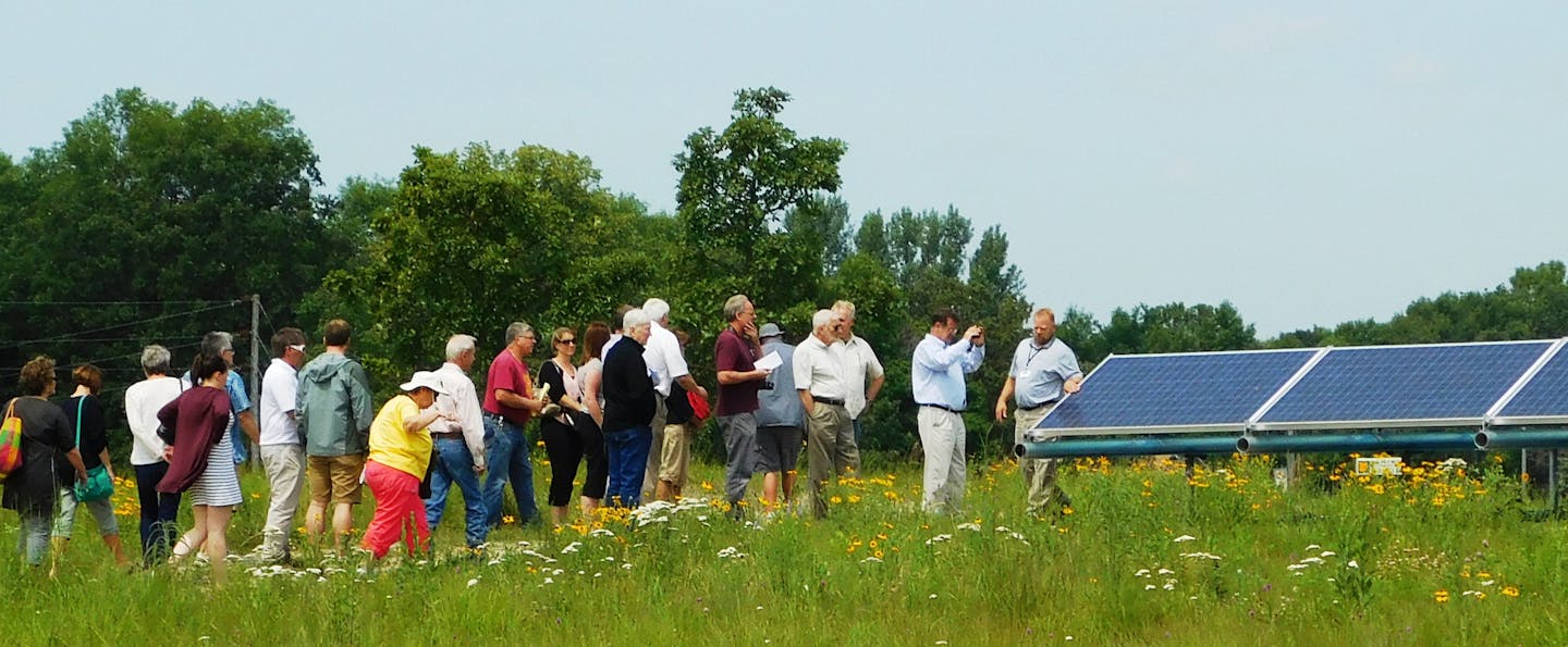 Consumers take a tour of the Lake Region Electric Cooperative community solar garden in Pelican Rapids, Minn. Photo by Clean Energy Resource Teams.