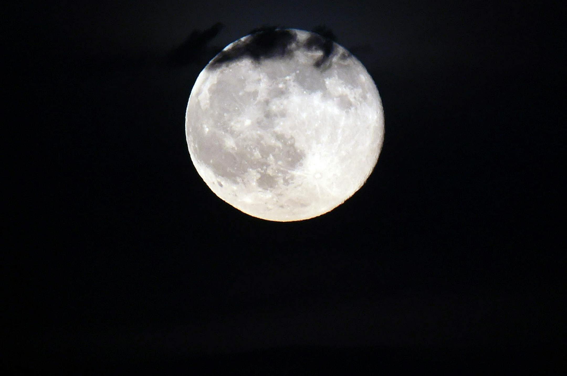 In this June 20 photo, a full moon rises, as seen from Ann Arbor, Mich.
