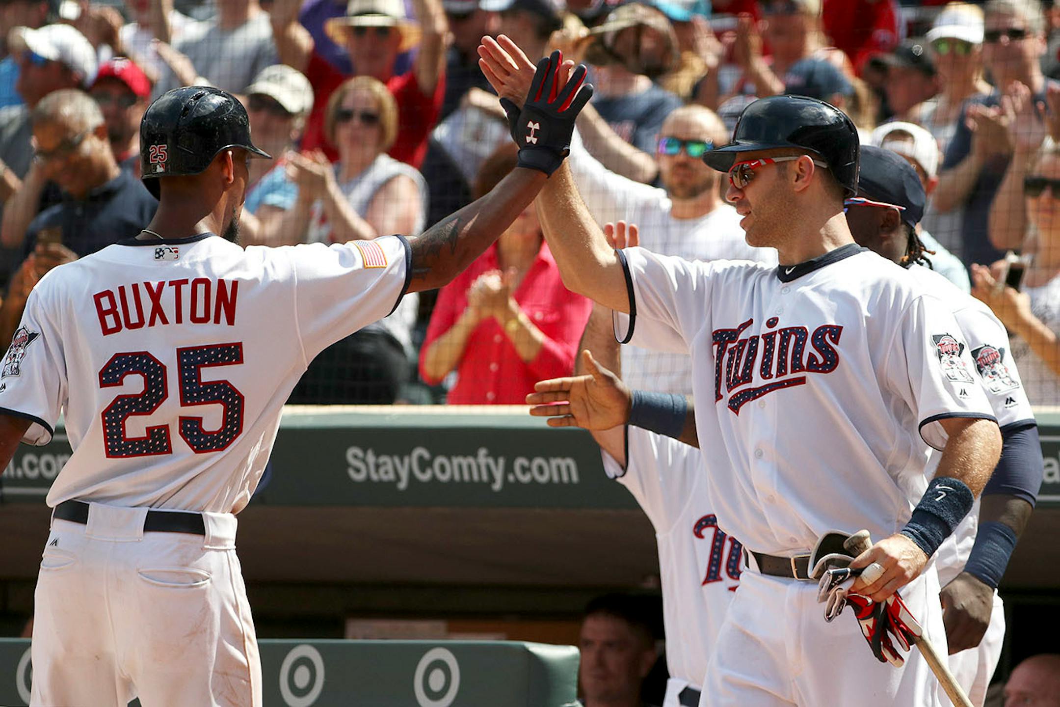 Minnesota Twins center fielder Byron Buxton (25) celebrated with Minnesota Twins first baseman Joe Mauer (7) after hitting a home run in the sixth inning.