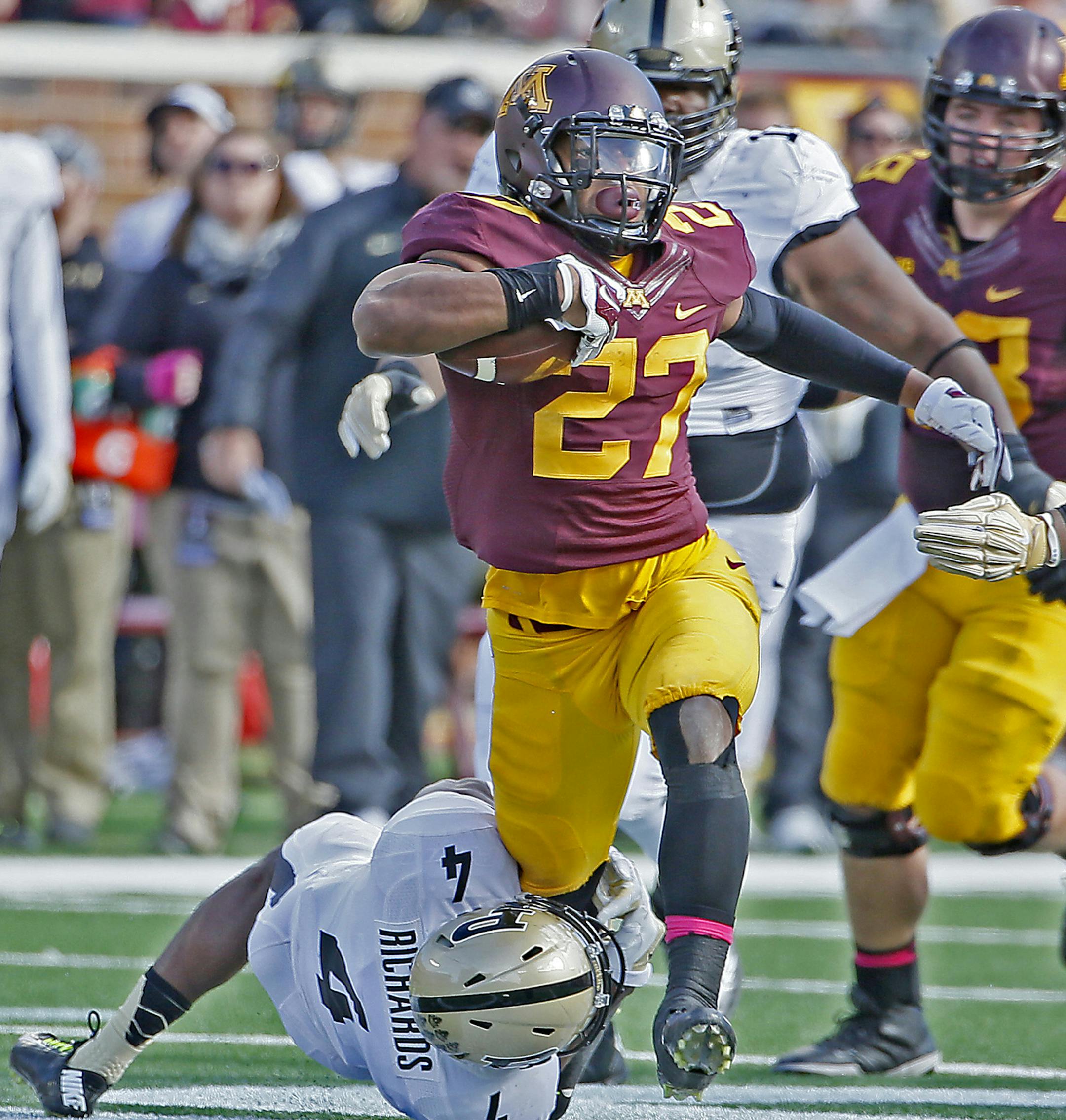 Gophers' running back David Cobb (27) can't be stopped by Purdue's safety Taylor Richards (4) in the first quarter as the Minnesota Gophers took on the Purdue Boilermakers, Saturday, Oct. 18, 2014 at TCF Bank Stadium in Minneapolis. Minnesota came out on top, 39-38. (Elizabeth Flores/Minneapolis Star Tribune/MCT) ORG XMIT: 1158853