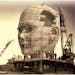 300 dpi 5 col x 7.25 in / 246x184 mm / 837x626 pixels Rick Nease color illustration shows the construction of a large head; cranes on scaffolding work