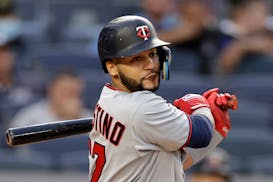 Minnesota Twins' Gilberto Celestino watches his RBI single during the 12th inning of the first baseball game of the team's doubleheader against the Ne
