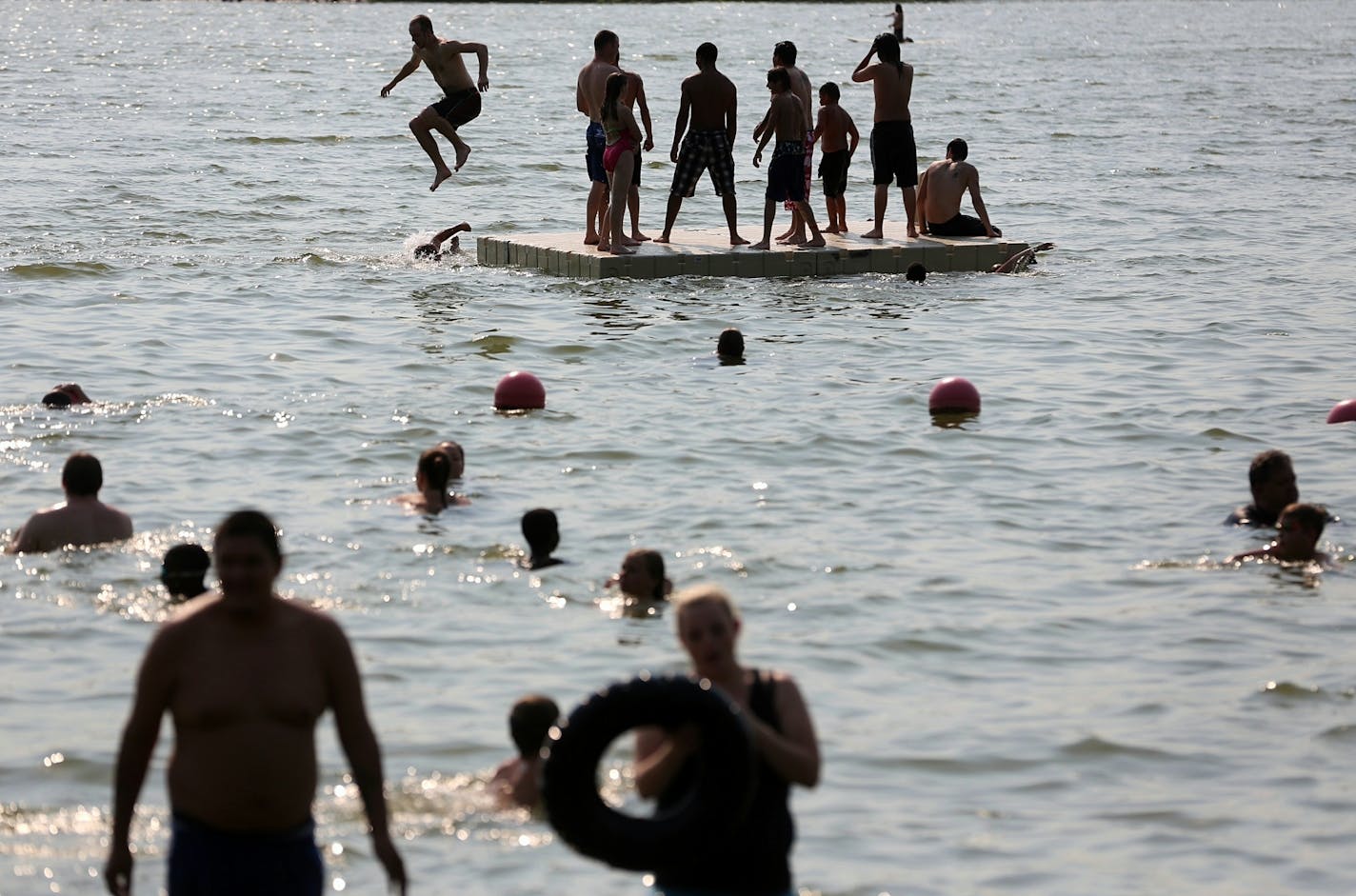 Beachgoers hit Lake Nokomis on a sweltering July day.