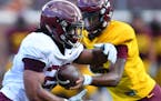 Gophers running back Kobe McCrary (22) ran the ball off a handoff by quarterback Denny Croft (11) during Saturday's scrimmage. ] (AARON LAVINSKY/STAR 
