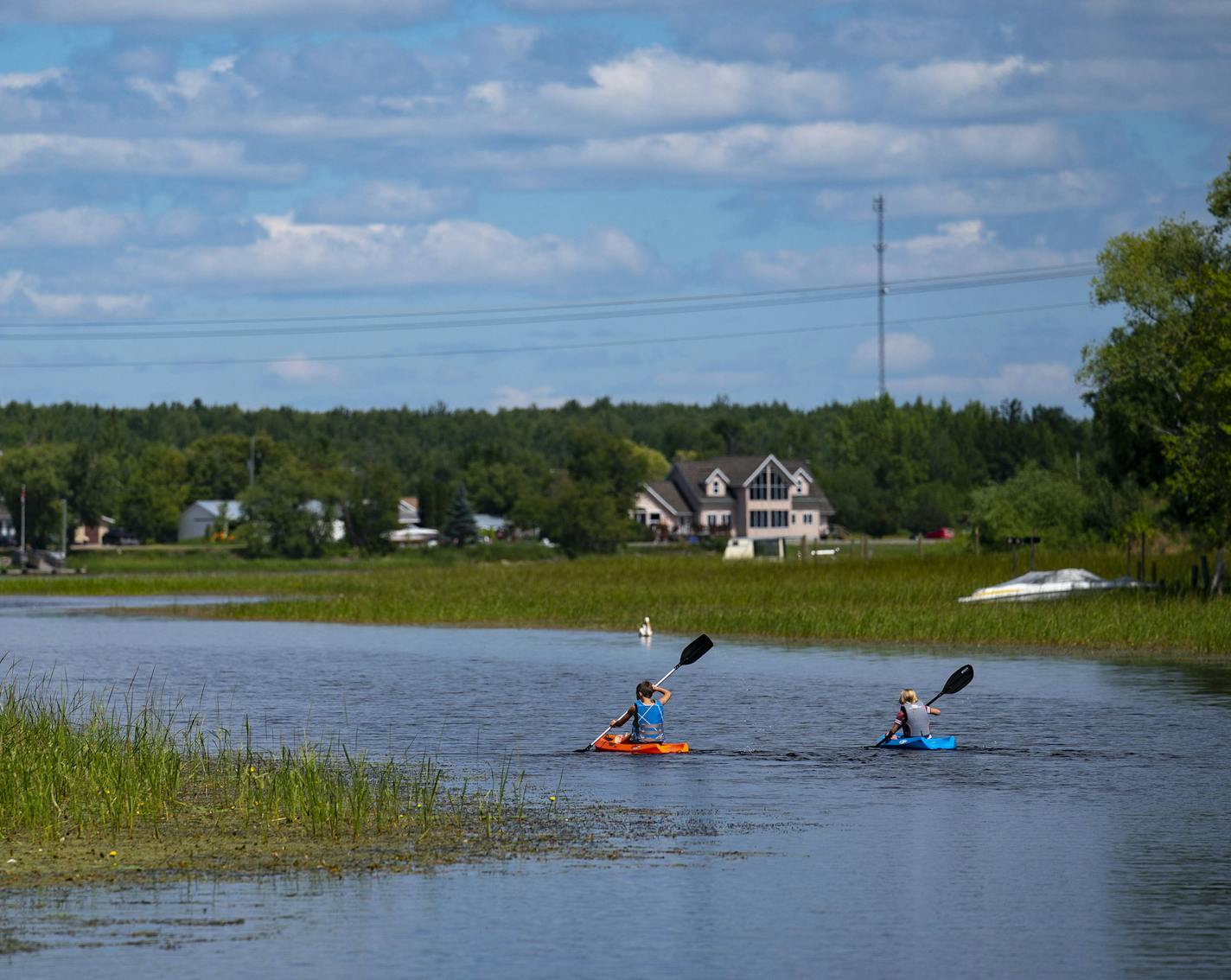 Two kids took advantage of the warm weather and kayaked up the Baudette River on Thursday July 30, 2020. ] ALEX KORMANN • alex.kormann@startribune.com Baudette, Minn. in Lake of the Woods County was one of the last towns in the state to get a confirmed COVID-19 case. The town sits right on the Canadian border and is often one of the last to be affected by things happening across the state and country.