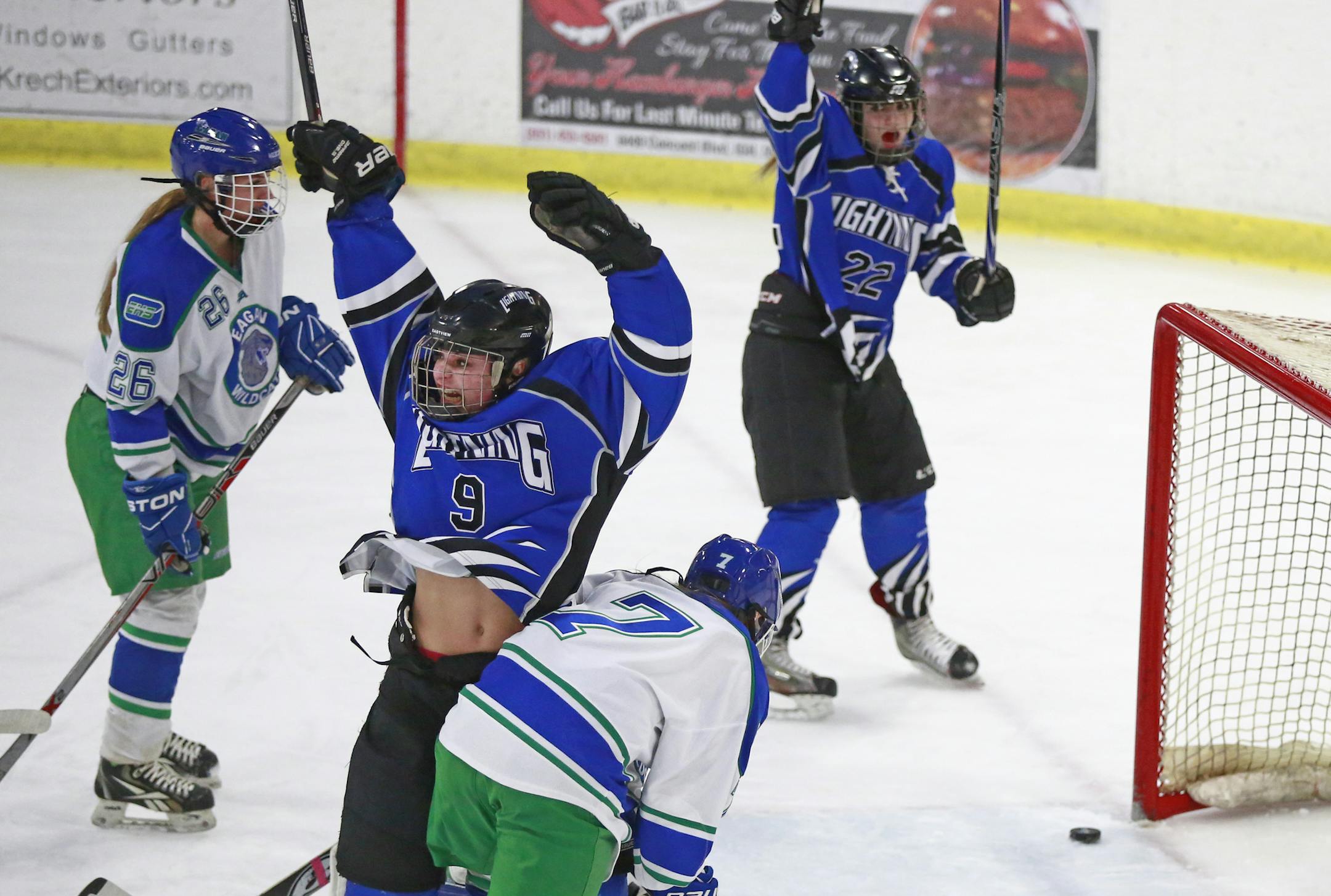 Eastview's Natalie Snodgrass (9) and Brooke Phalen (22) celebrate a first-period goal from teammate Kealie Espinda Banick (not pictured) in the Lightnings‚Äô 6-4 victory over Eagan in the Class 2A, Section 3 championship game at Veterans Memorial Community Center in Inver Grove Heights on Feb. 11. Photo by Chris Juhn, Minnesota Hockey Hub