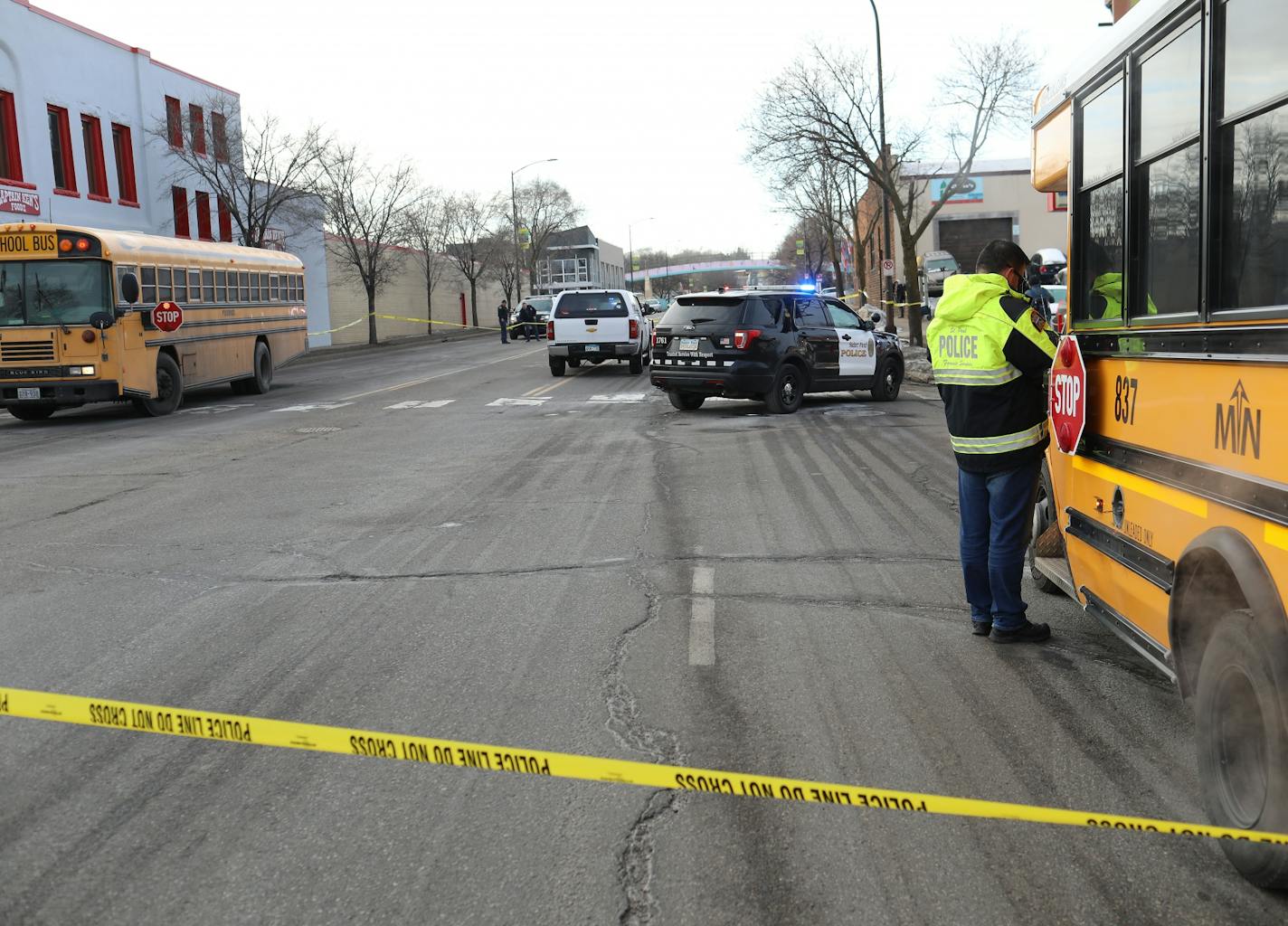 A police officer talks to a school bus driver at the scene along Robert St. Thursday morning on St. Paul's west side.