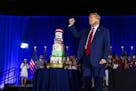 Former President Donald Trump stands next to a birthday cake after speaking during an event in West Palm Beach, Fla., on Friday, June 14, 2024. As he 