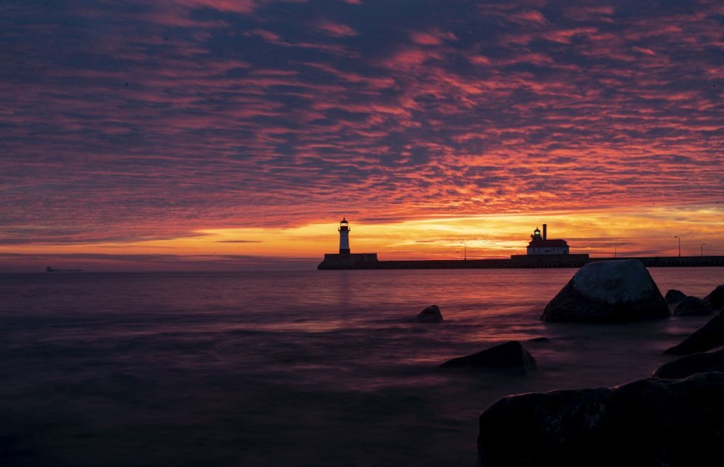 The first sunrise of 2020 brought deep orange and pink colors over the Duluth Harbor North and South Breakwater Lighthouses in Duluth, MN on January 1, 2020.