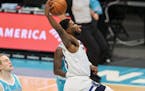 Timberwolves guard Malik Beasley drives to the basket against Charlotte