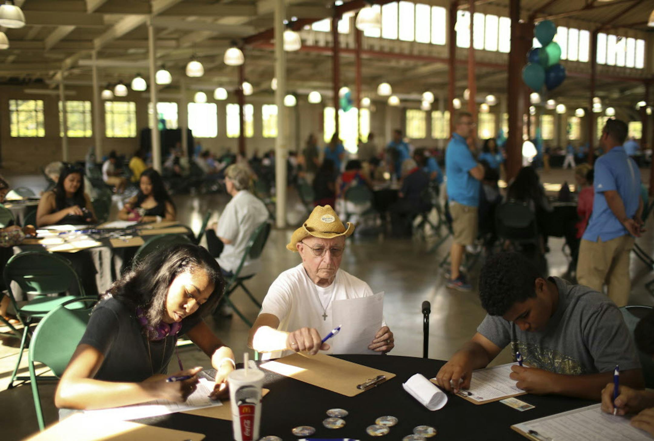 Ed Forde, 77, finished filling out a job application at the job fair Wednesday afternoon. He was seated at a table with Keyara Clardy, 18, and Carter Vitelli, 16, who were also working on their applications. ] JEFF WHEELER ï jeff.wheeler@startribune.com With 600 jobs to fill, the Minnesota State Fair held a job fair for the first time Wednesday afternoon, June 29, 2016 in the Progress Center on the fairgrounds in Falcon Heights.