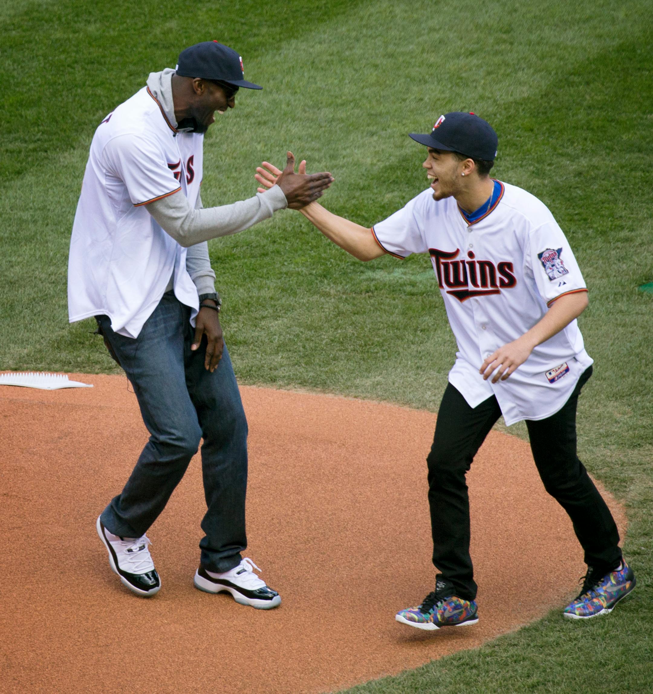 Timberwolves Kevin Garnett and Duke Star and former Apple Valley High School basketball player Tyus Jones shake hands on the mound after Garnett threw out the first pitch at the Minnesota Twins Home Opener Monday afternoon at Target Field.] Minneapolis, MN - 4/13/2015