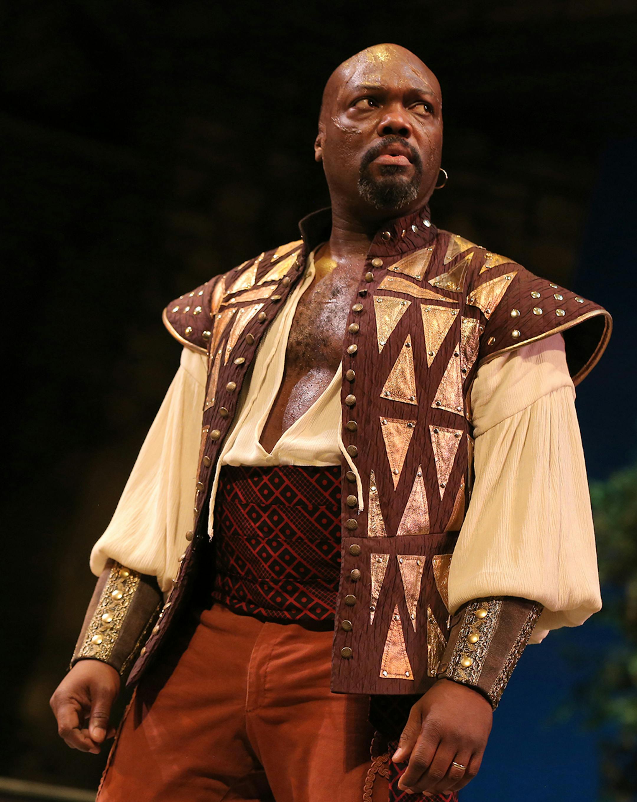 Peter Macon (Othello) in the Guthrie's production of Othello, by William Shakespeare. Directed by Marion McClinton, set design by Marjorie Bradley Kellogg, costume design by ESOSA and lighting design by Michael Wangen. March 8 - April 20, 2014 on the Wurtele Thrust Stage at the Guthrie Theater, Minneapolis. Photo by Joan Marcus.