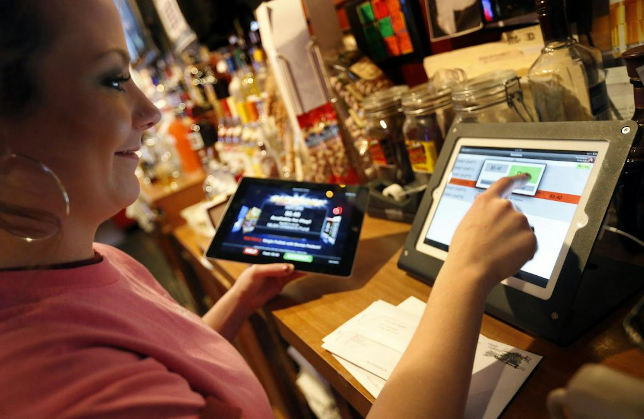 Bartender Jessica Dahlke prepared an electronic pulltab game at Skinner's Pub.