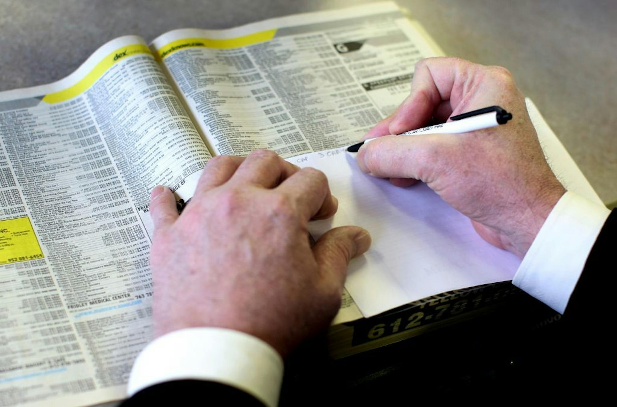 Bloomington resident Rob Wright copies down phone numbers for potential employers at the Minnesota WorkForce Center-Hennepin South in Bloomington January 12, 2012. Wright was told his unemployment would end in March. He got a letter two weeks ago saying it ends Saturday.