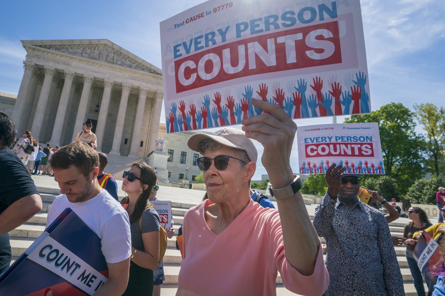 FILE - In this April 23, 2019 file photo, Immigration activists rally outside the Supreme Court as the justices hear arguments over the Trump administration's plan to ask about citizenship on the 2020 census, in Washington. Voting rights activists argue that newly discovered 2015 correspondence between a GOP redistricting expert and a current Census Bureau official bolster arguments that discrimination motivated efforts to add a citizenship question to the 2020 population survey. The plaintiffs,